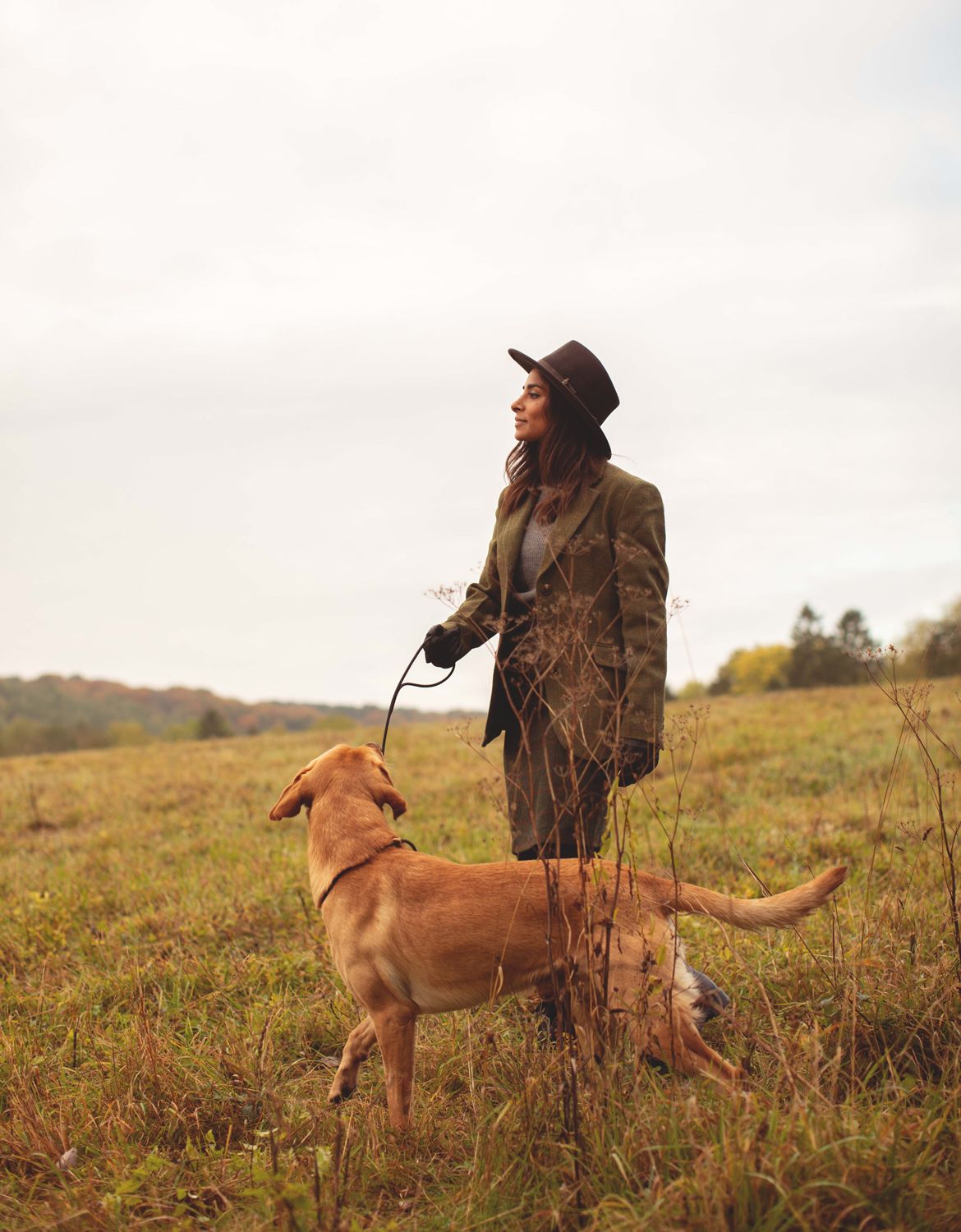 Woman walking in a field with her dog